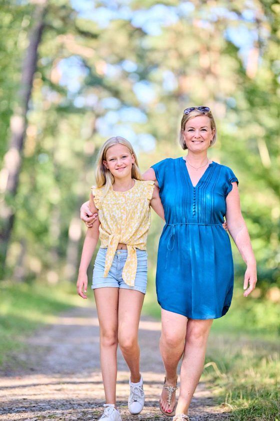 Mother and daughter walking in the forest