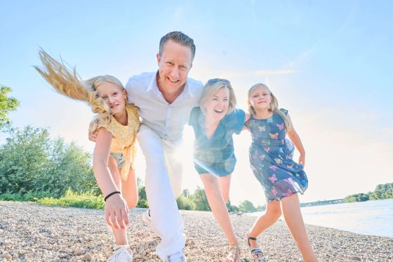 Laughing family on the beach in summer.