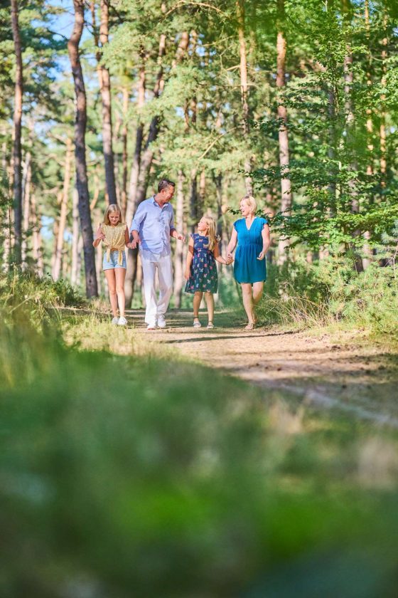 Family taking a happy walk in the forest