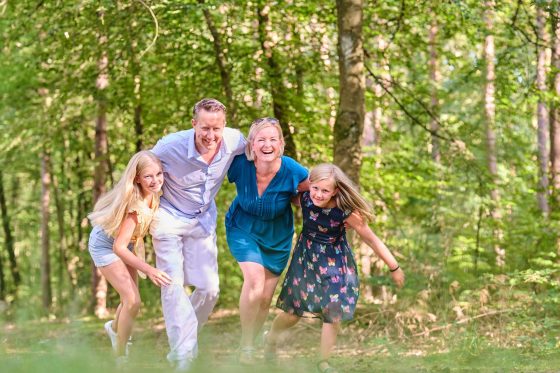 Family laughs in the forest