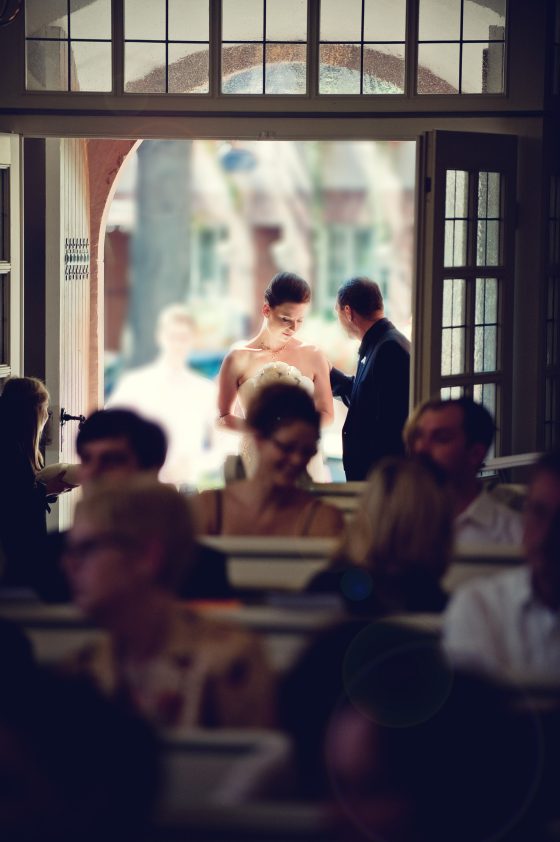 Bride at the church entrance with attendants