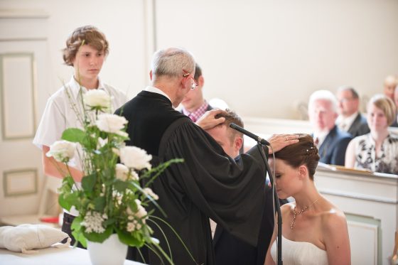 Priest blesses a couple in the church.