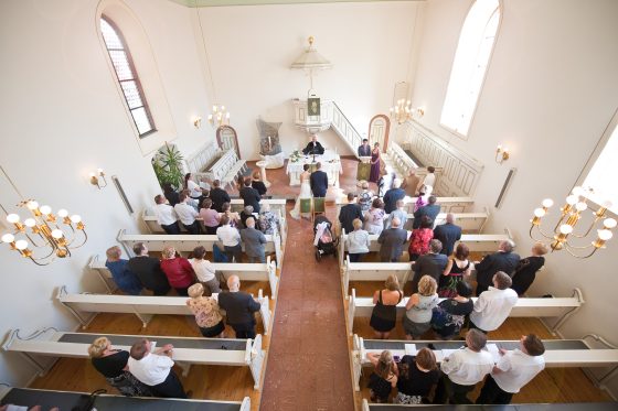 Wedding ceremony in a church, guests seen from above.
