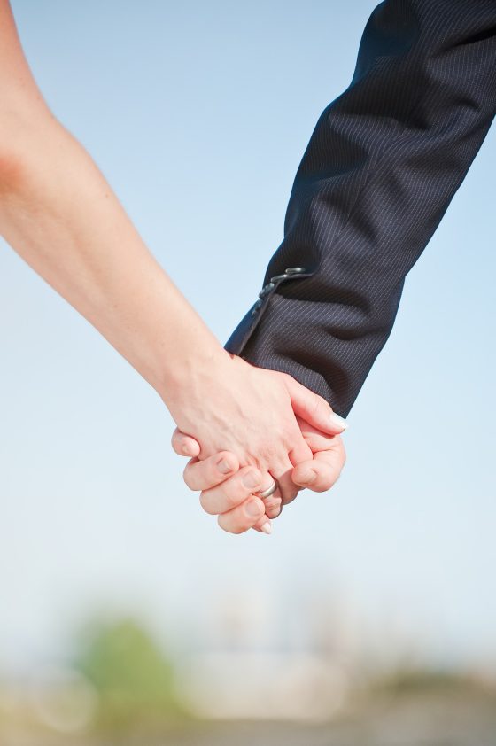 Couple holding hands outdoors