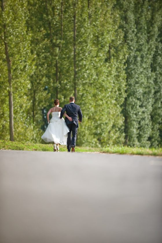 Bride and groom walking on a country road