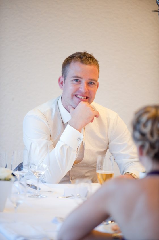 Man smiling at a festive dinner
